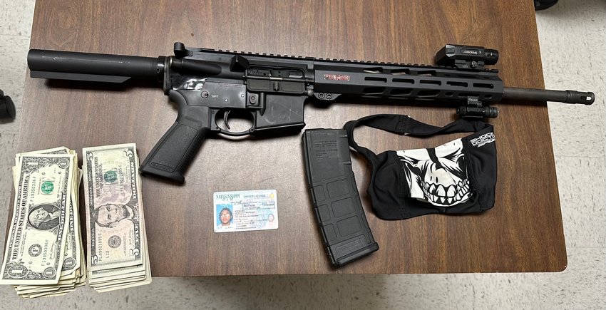 Cash, a mask and the gun used in the robbery. Authorities say the AR-15 style long rifle was reported stolen from Madison County.